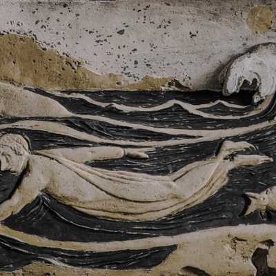 Stone engraving. Offraed swimming with something.